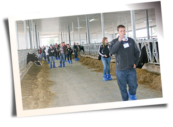 tour participants in Evergreen Holsteins’ new five-row, all steel heifer barn enjoying refreshments